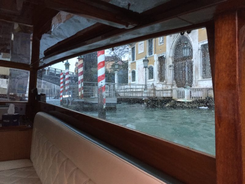 Finding rain in Venice? All the more reason to travel by boat taxi. Photo credit: Michael Ciavardini