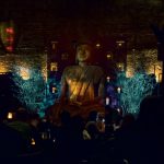 A tall Buddha in the low-lit dining room of Tao Uptown restaurant in New York City. Photo credit: L. Tripoli.