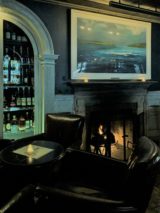 History and whiskey at Fraunces Tavern in Manhattan. Shown, a dining room at the tavern with a fireplace and a cabinet with bottles of liquor. Photo credit: L. Tripoli.